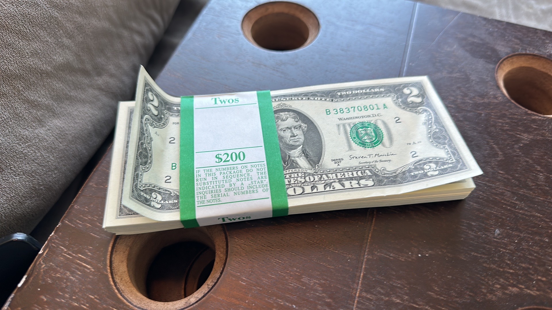A bank strap of crisp two-dollar notes